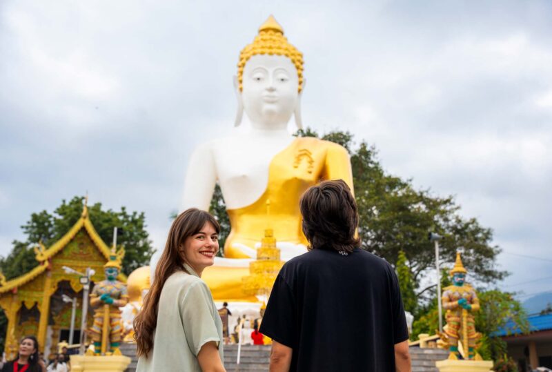 chiang mai couple in front of buddha statue