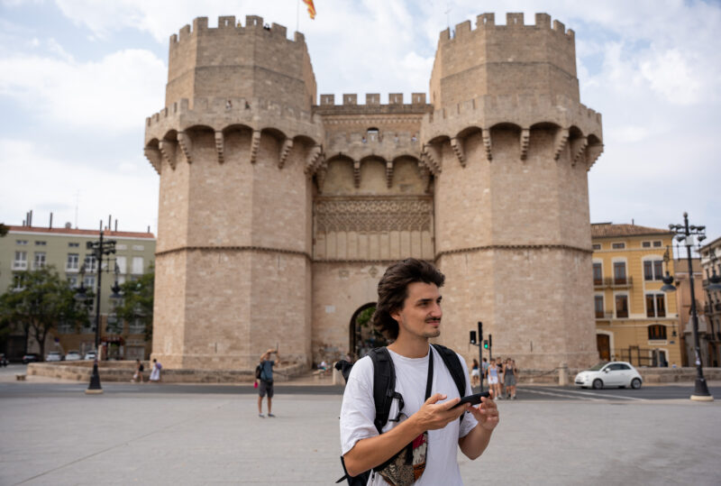 person standing in from of the the Serrano towers in Valencia