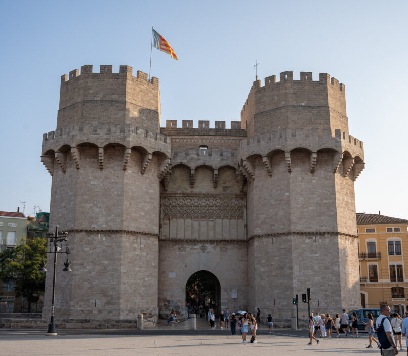 medieval building with two towers surrounded by tourists